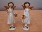 Preview: Stehender Engel mit einem Stern im Porzellan-Look 20 cm